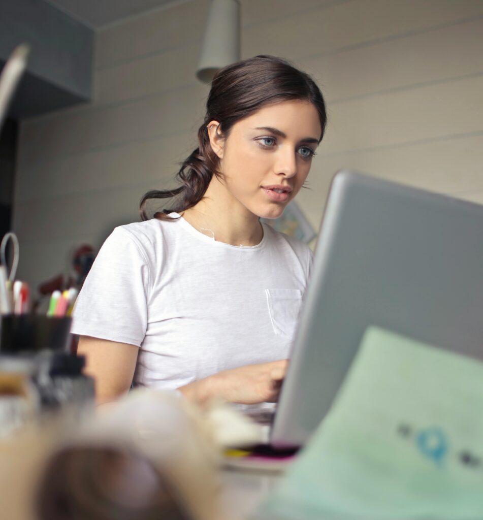 Young woman attentively working on her laptop in a digital marketing